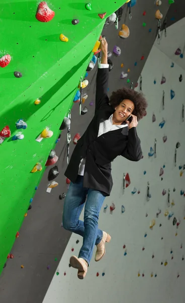 woman on artificial climbing wall
