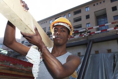 young african man working in construction site  clipart