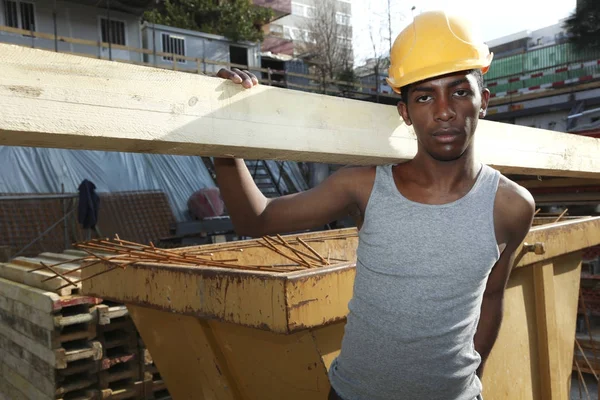 Young african man working in construction site — Stock Photo, Image