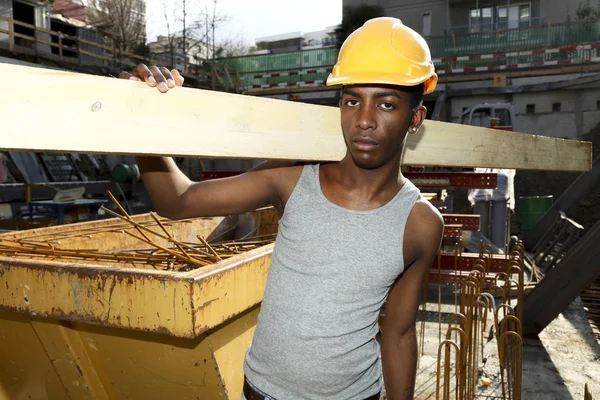 Young african man working in construction site — Stock Photo, Image