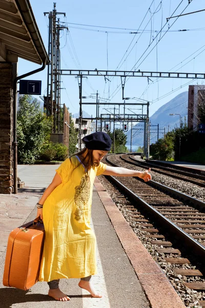 Niña esperando el tren en una estación — Foto de Stock