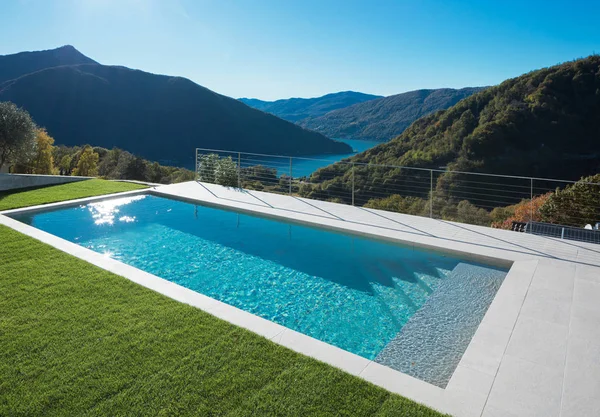 Modern swimming pool with lake and valley view — Stock Photo, Image