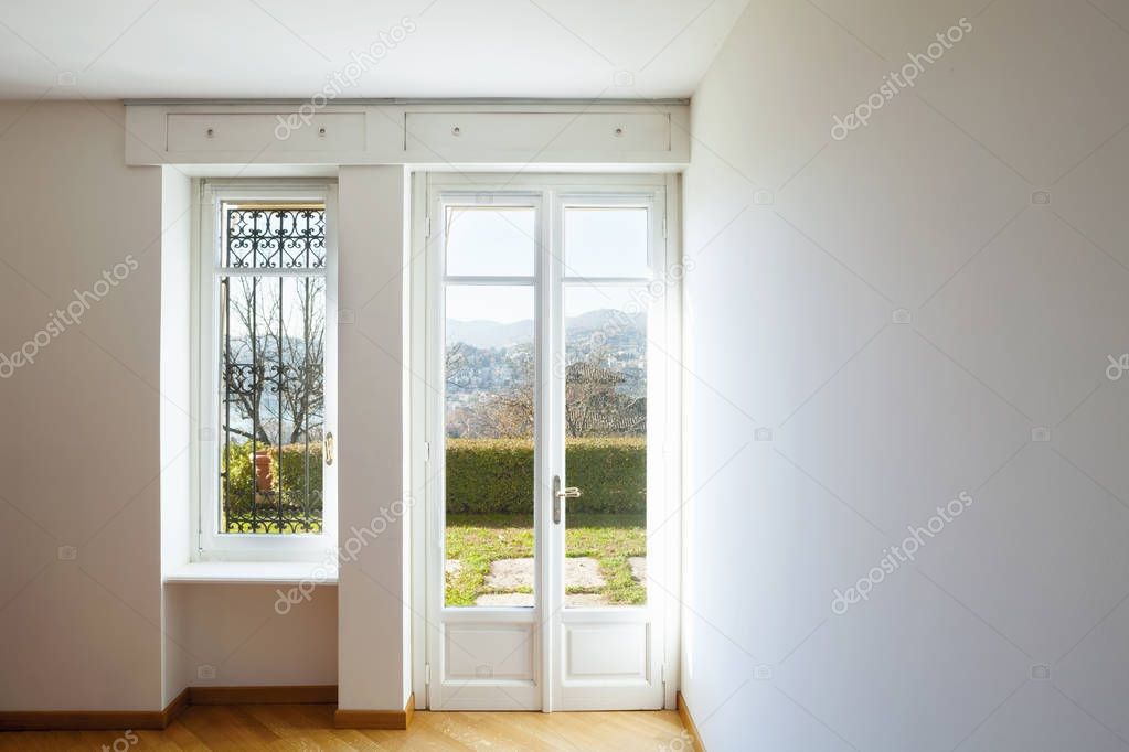 Empty white room with window