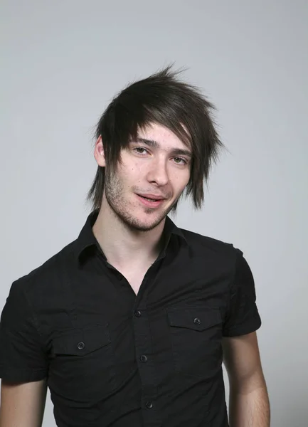 Portrait of young man over grey background — Stock Photo, Image