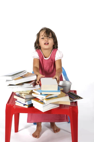 Ung student flicka med små röda skrivbord — Stockfoto