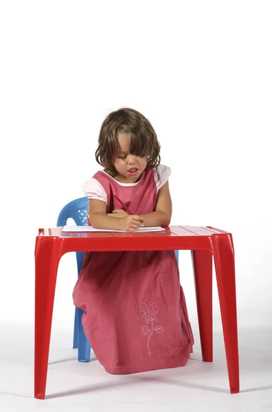 Young student girl with small red desk — Stock Photo, Image