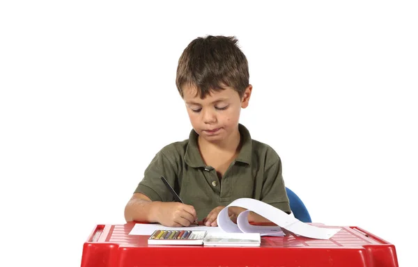 Niño con escritorio rojo —  Fotos de Stock