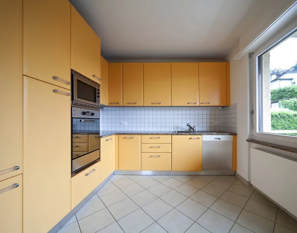 Orange furnished and tiled kitchen — Stock Photo, Image