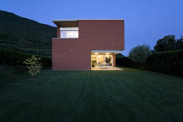 Maison en brique, vue du jardin, nuit — Photo