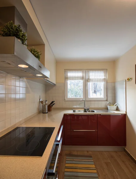 Red modern kitchen with new appliances — Stock Photo, Image