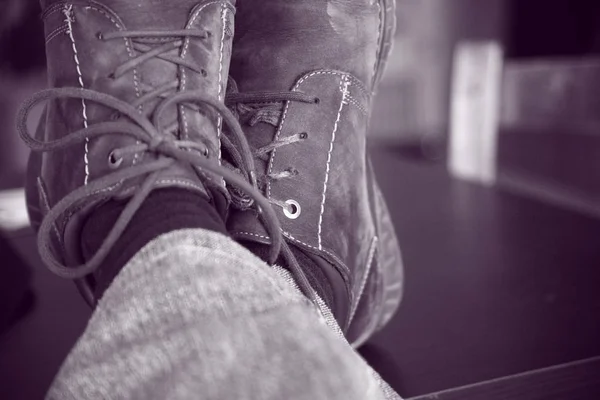 Feet crossed with worn shoes — Stock Photo, Image