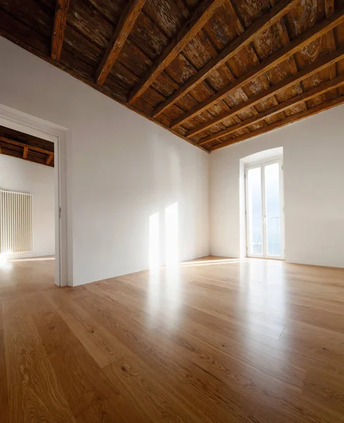 Quarto vazio com grandes janelas e vigas antigas — Fotografia de Stock