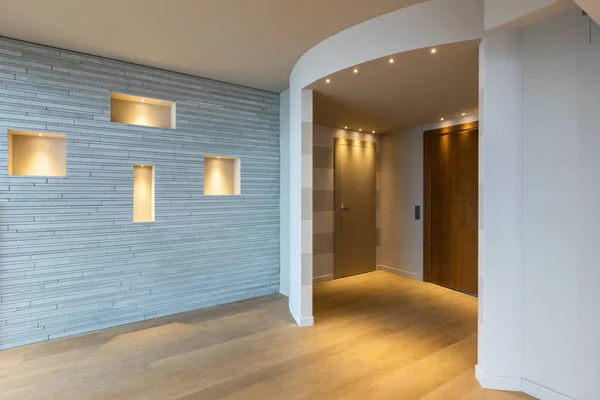 Modern apartment entrance with gray stripes on the wall