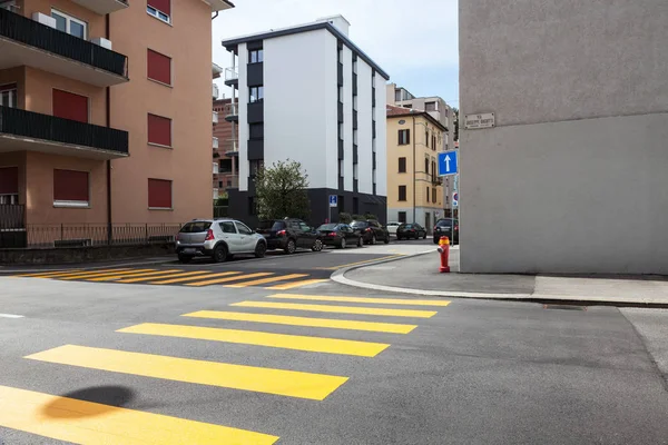Cross with small buildings and yellow crosswalks