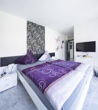 Çok parlak yatak odası, renkli battaniye ve büyük yastıklar