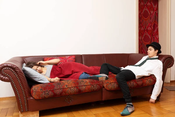 Young Couple Lying Sofa She Covered Blanket Businessman — Stock Photo, Image