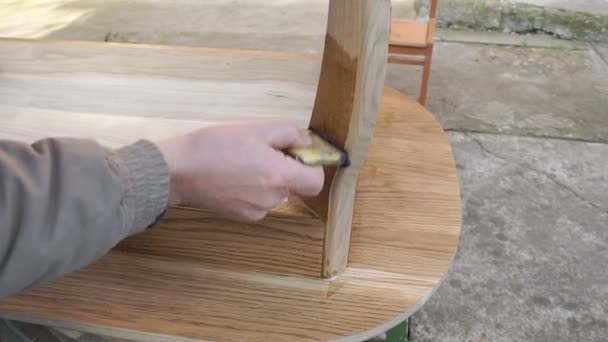 Carpenter is covering table by lacquer — Stock Video