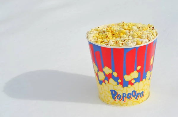 popcorn bucket in winter standing on snow