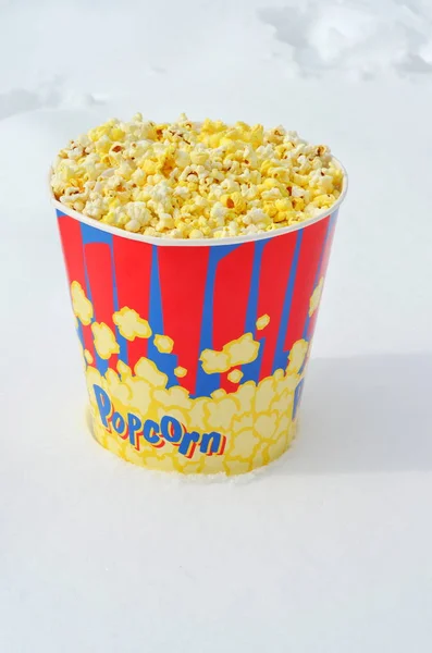 popcorn bucket in winter standing on snow