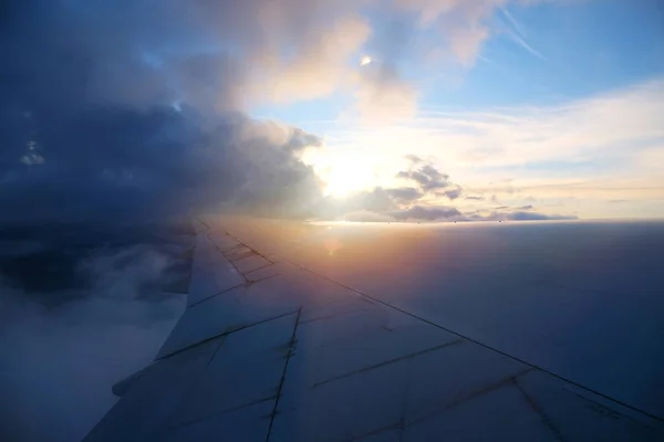 Vue de la fenêtre de l'avion avec ciel et nuages blancs au coucher du soleil — Photo