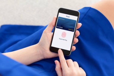 telefon ile banka kartı ve app touch ödeme tutan kadın 