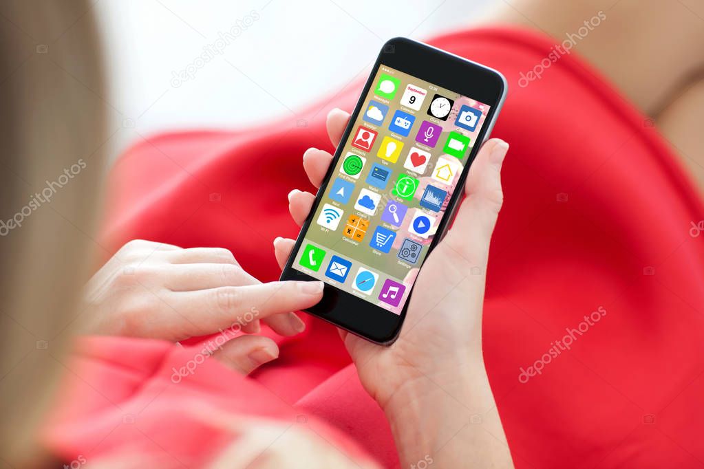 woman red dress holding phone with home screen icons apps