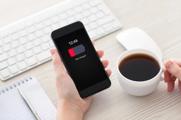 Women hands holding phone with low charged battery on screen — Stock Photo, Image