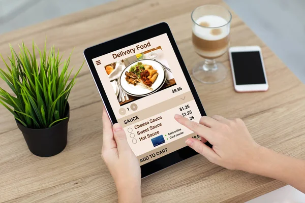 Woman hands holding computer tablet with app delivery food scree — Stock Photo, Image