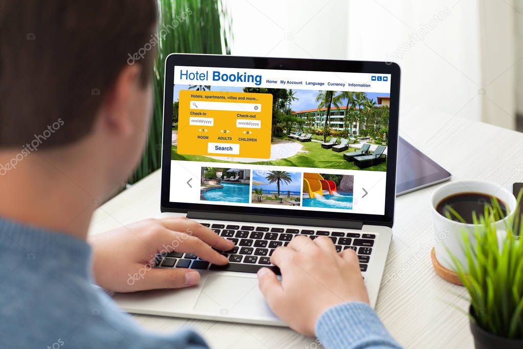 man typing laptop keyboard with online search booking hotel scre