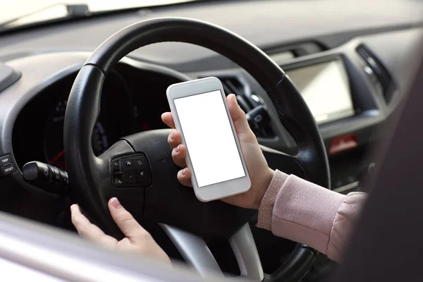 Female hands holding phone with isolated screen behind wheel car — Stock Photo, Image