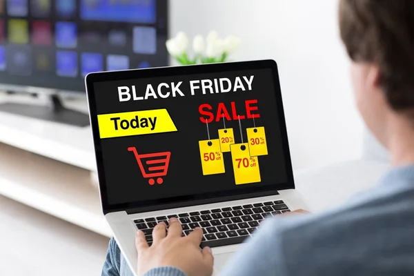 Man typing on laptop keyboard with sale black friday screen — Stock Photo, Image