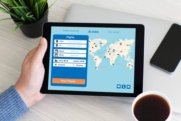Man hand holding computer tablet with application search air tic — Stok Foto