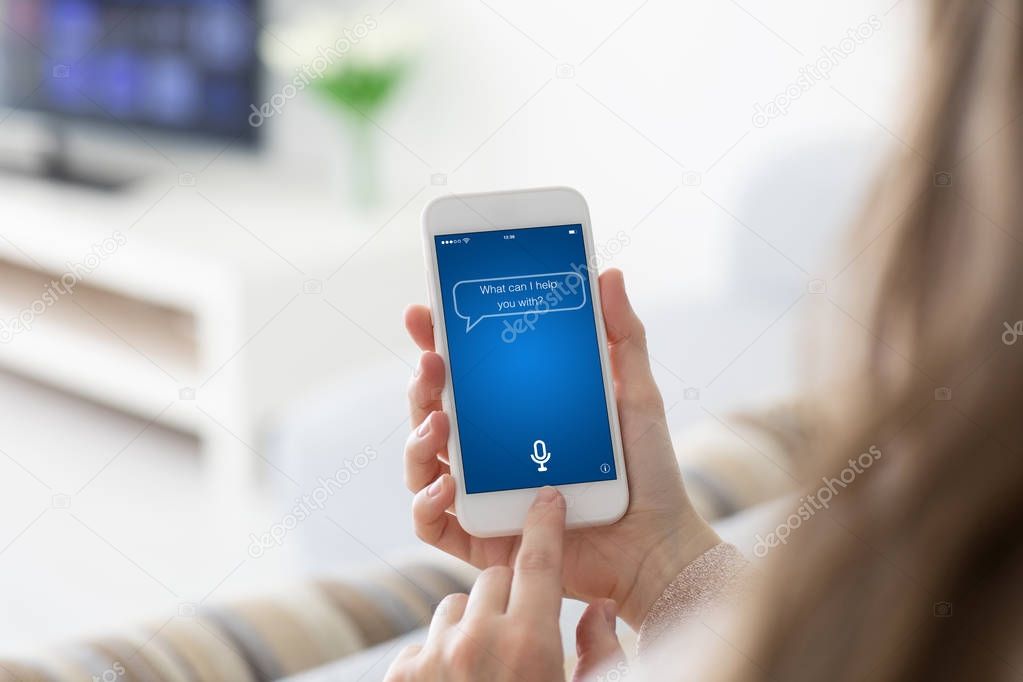 Female hands holding phone with app personal assistant on screen