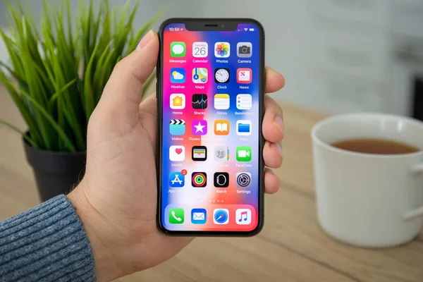 Man hand holding iPhone X with IOS 11 on screen — Stok Foto