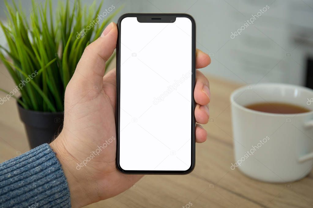 Male hand holding black touch phone with isolated screen