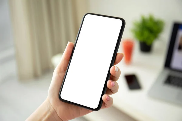 Female hands holding phone with isolated screen in the room — Stock Photo, Image