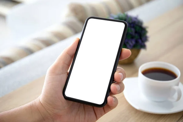 Male hands holding phone with isolated screen in room — Stock Photo, Image