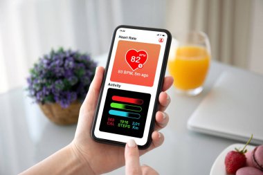 uygulamalı kalp ve aktivite ile telefon tutan kadın elleri