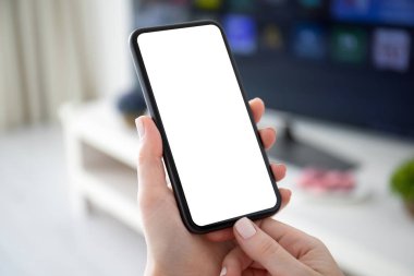 Tv 'nin izole ekran arka planına sahip kadın eller telefonu tutuyor