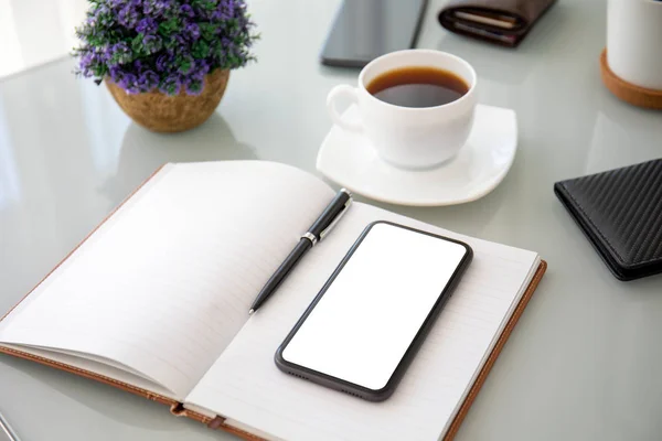 Phone with isolated screen on notebook and desk in office — 스톡 사진