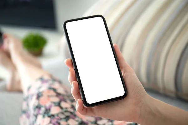 Female hand holding phone with isolated screen in the room — Stock Photo, Image