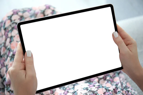 female hands floral print dress holding computer tablet isolated