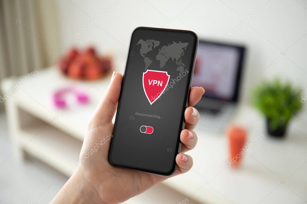 female hand holding phone with app vpn on the screen