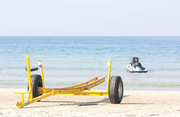 Empty yellow boat trailer on the beach — 스톡 사진