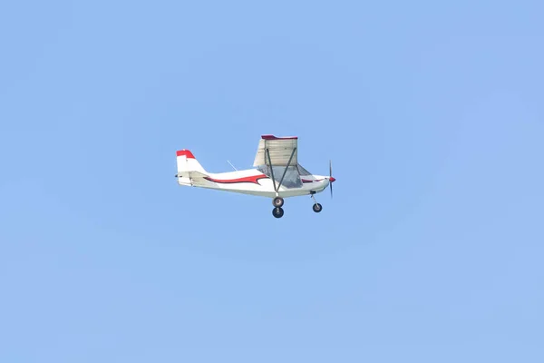 Ein kleines Vergnügungsflugzeug fliegt in den blauen Himmel — Stockfoto