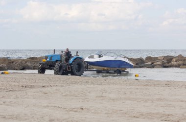 tractor with trailer launches the boat into the water