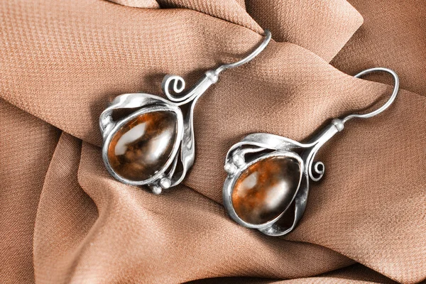 Earrings on cloth — Stock Photo, Image