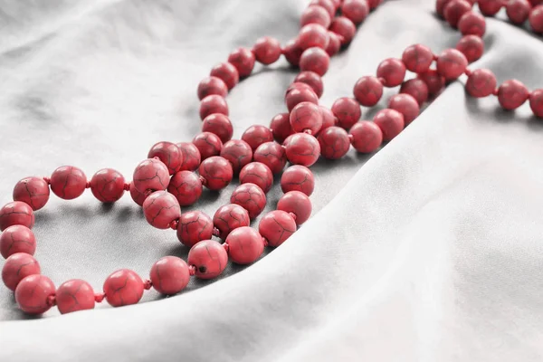 Coral beads on satin — Stock Photo, Image