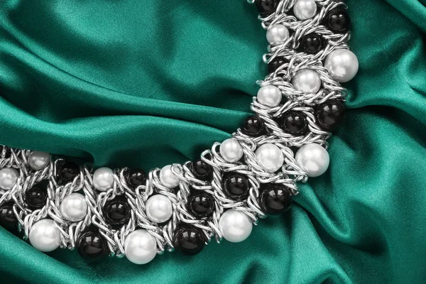 Necklace on silk — Stock Photo, Image