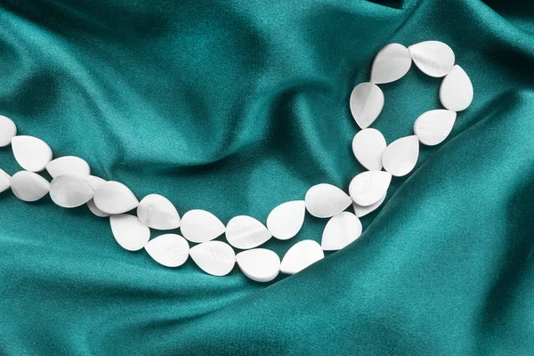 Necklace on silk — Stock Photo, Image